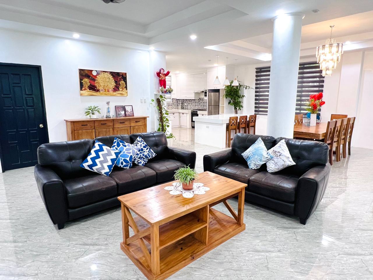 Open living and dining space in Grande Second with a chandelier over the dining table